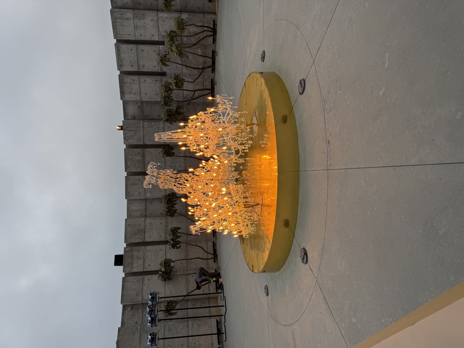 Golden illuminated sculptural centerpiece at venue entrance