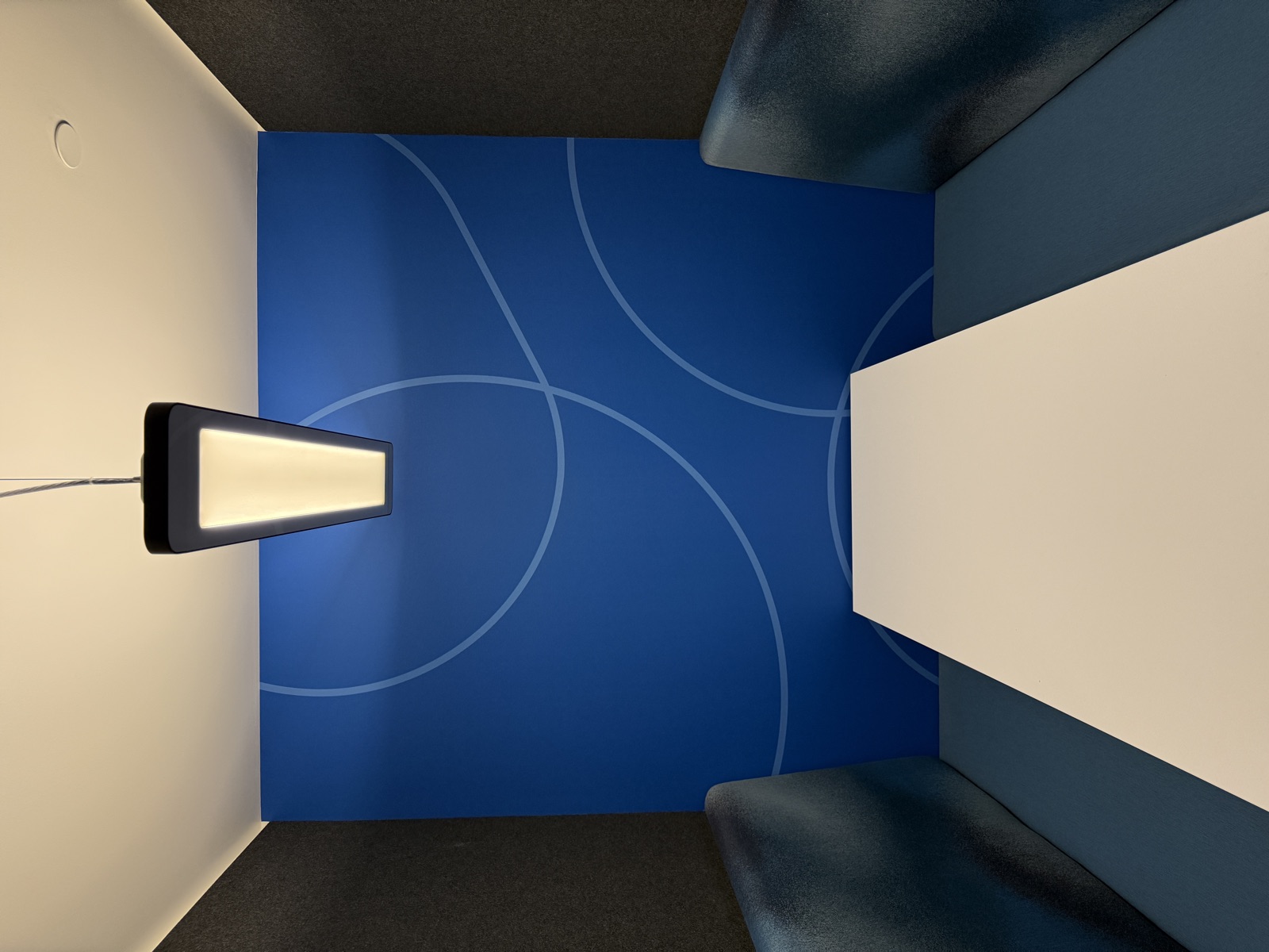 Blue accent wall with subtle geometric circle pattern in phone booth