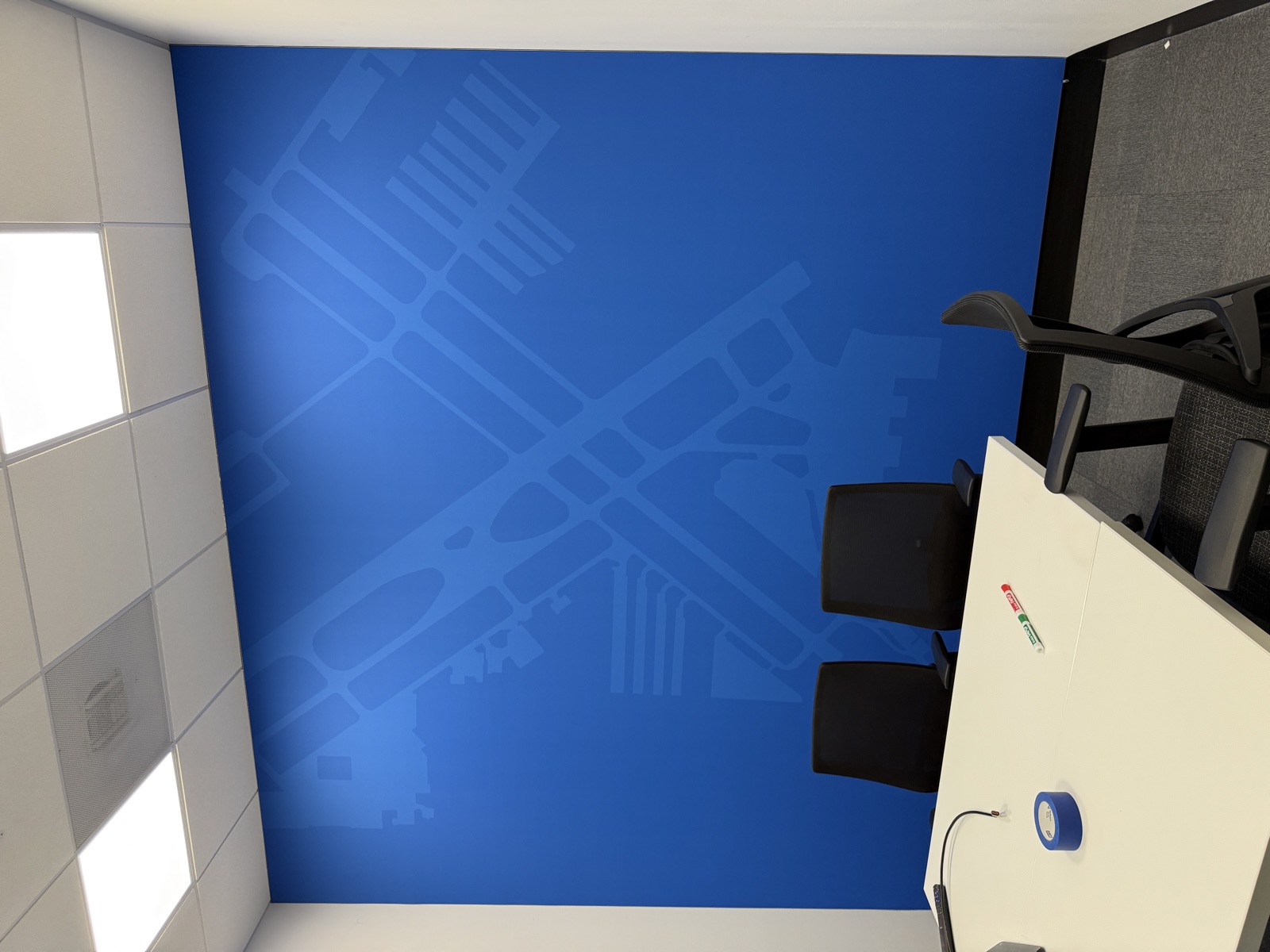 Blue wall with subtle circuit board pattern in conference room
