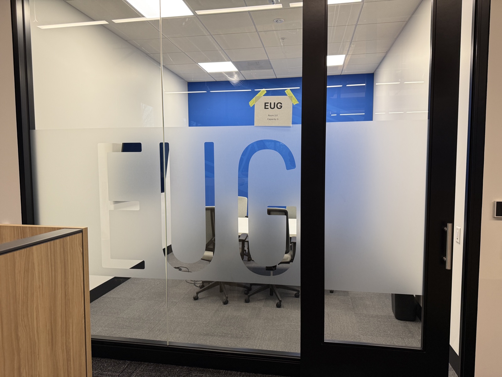 EUG airport code frosted glass at conference room entry