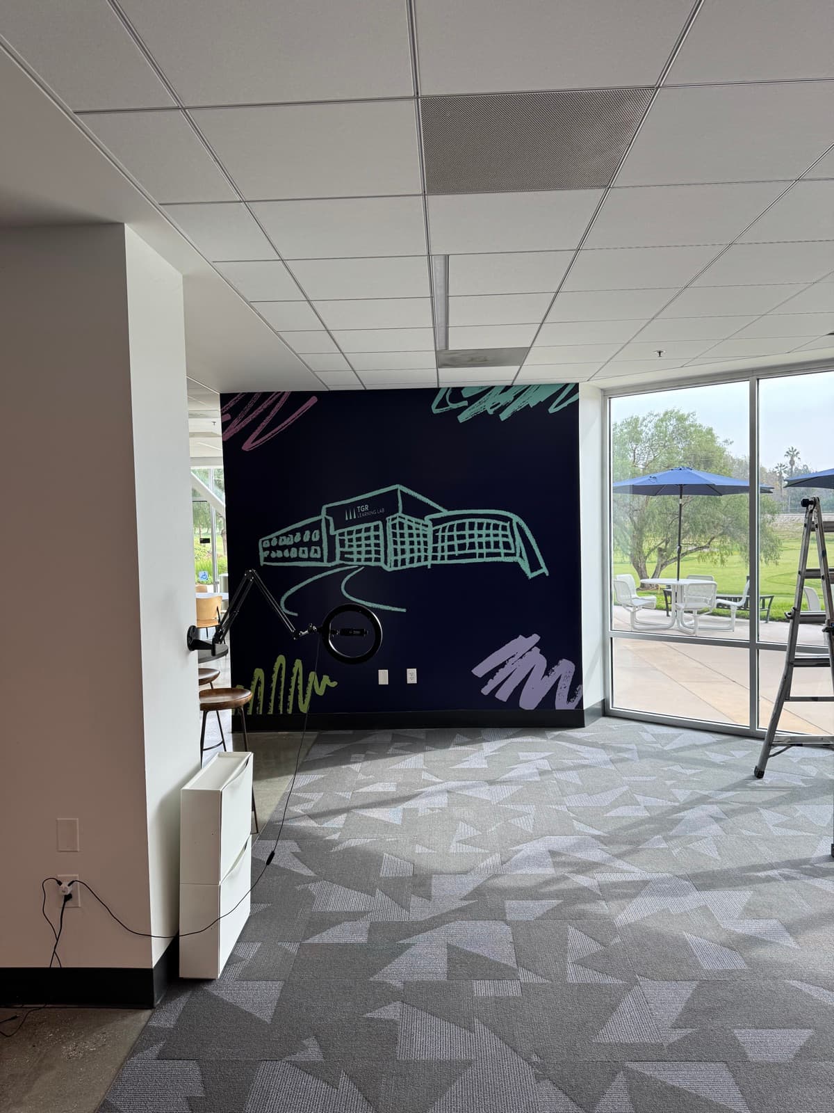 Dark accent wall with neon-style city illustration and geometric patterns