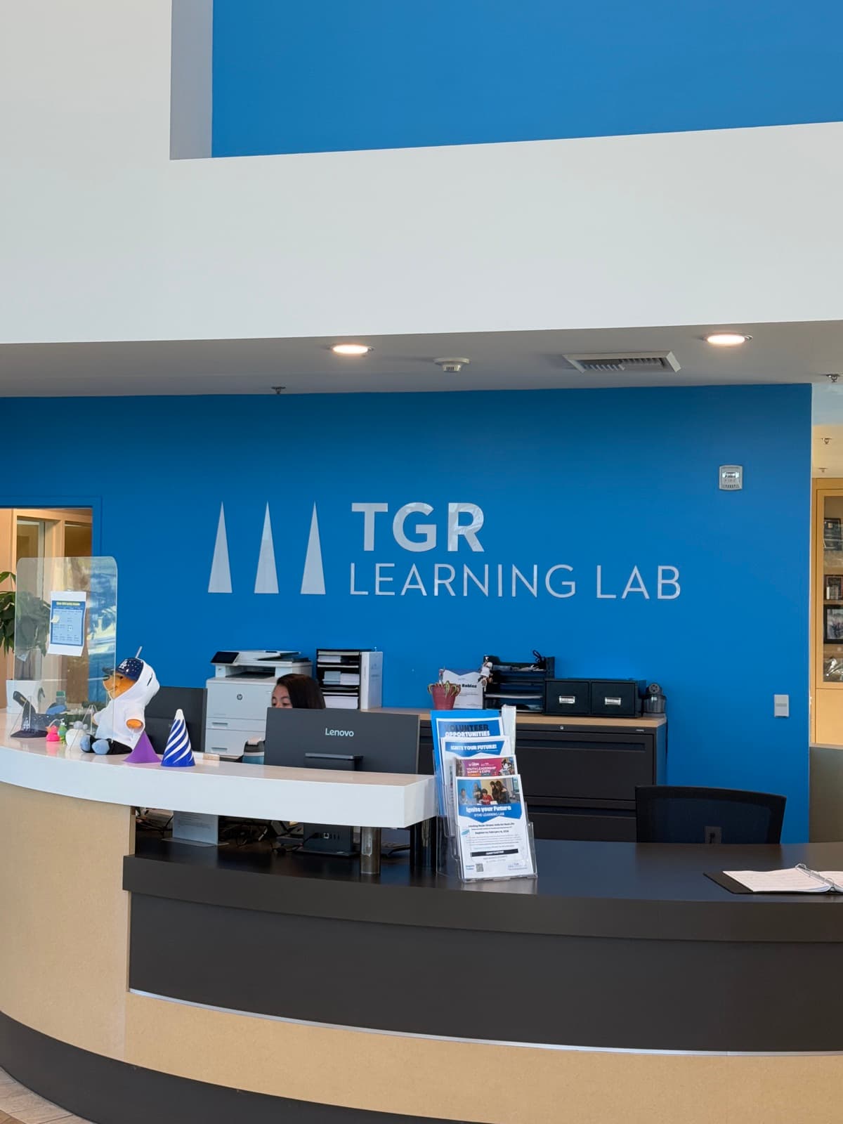 TGR Learning Lab logo on blue branded wall in main lobby